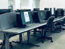 desktops with paper saying “chair to remain vacant”