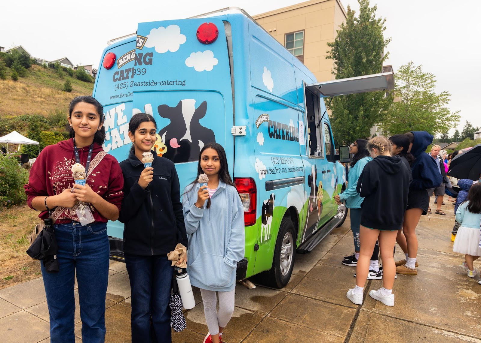 Issaquah residents enjoying ice cream from Ben & Jerry’s mobile truck after the ribbon-cutting ceremony