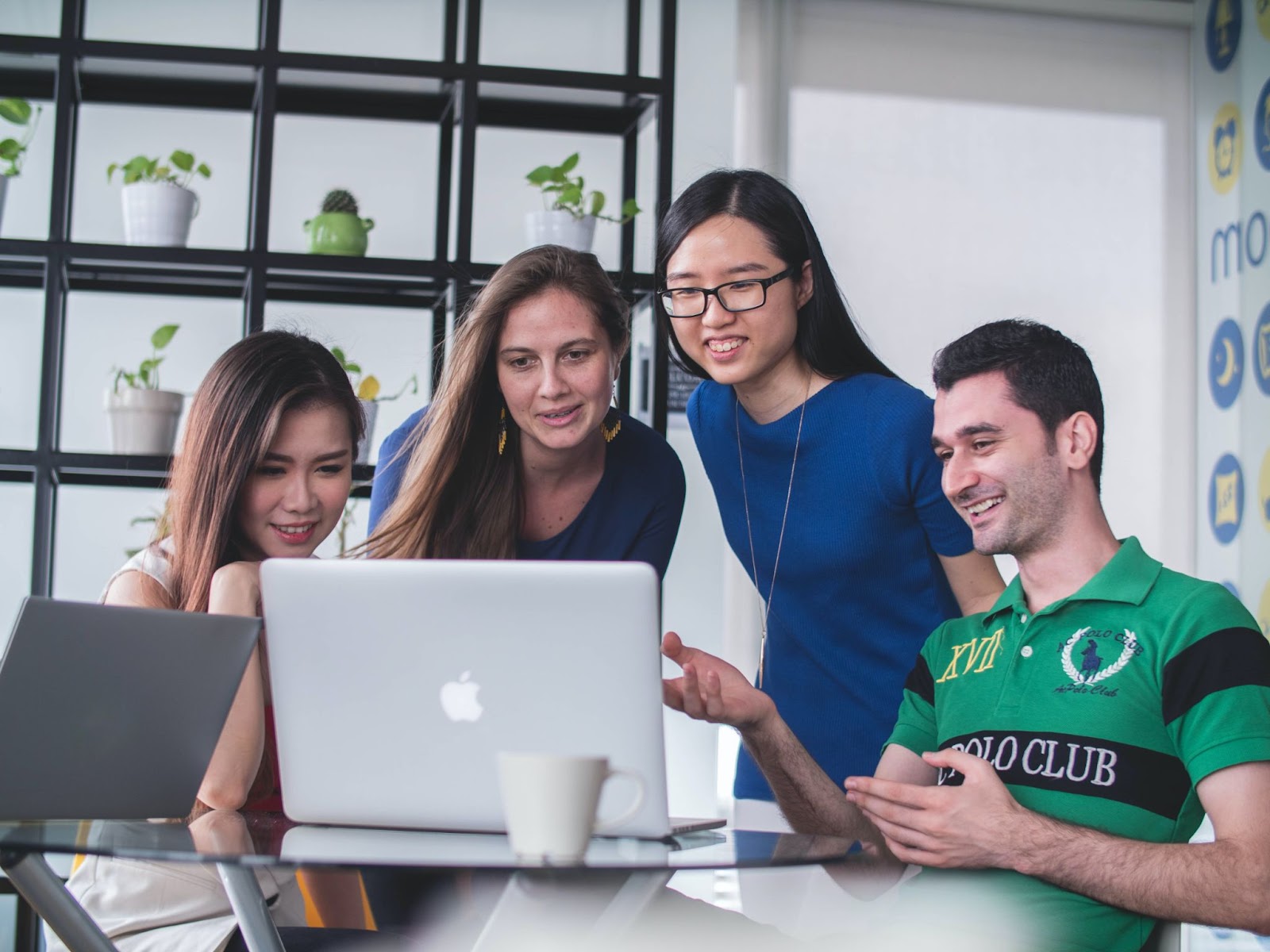 gathered around a laptop for a meeting