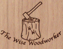A tree stump with business initials used as part of the wood grain with an axe in the tree stump and a traditional-style font.