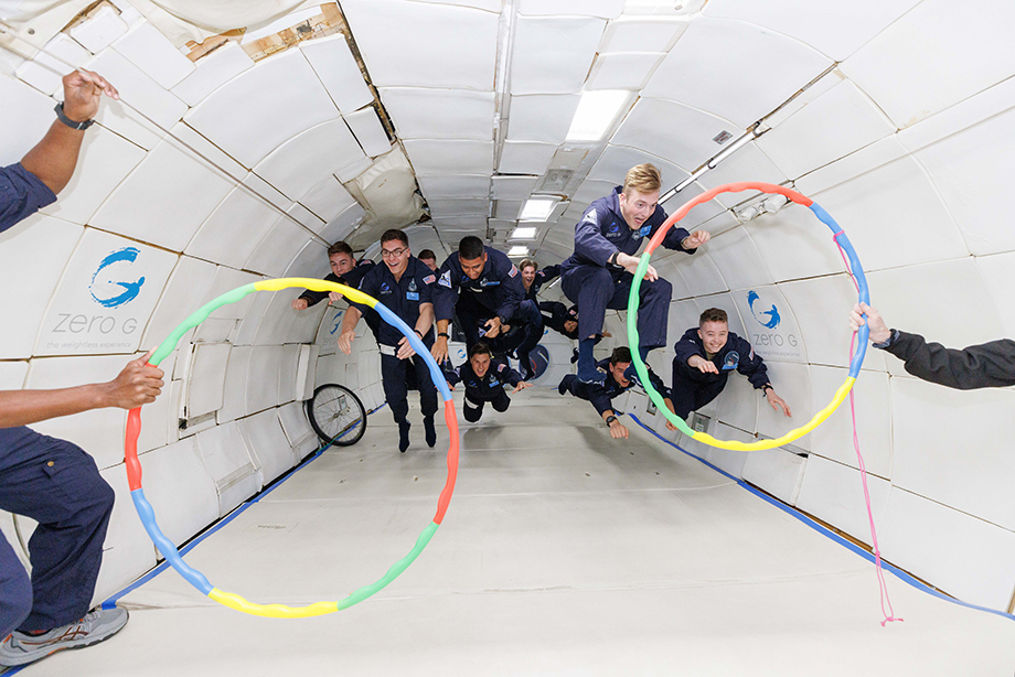 US Space Force cadets "superman" their way to two hoops as they experience zero gravity on a Zero G aircraft, captured by photographer Steve Boxall.