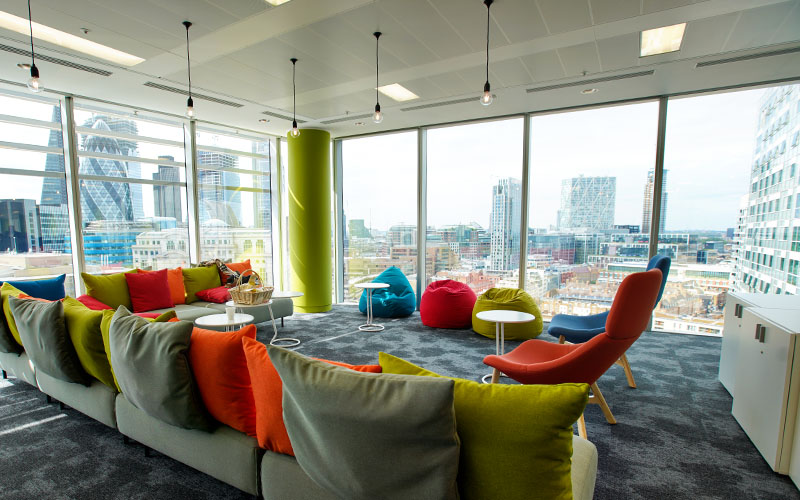 A lounge area slash meeting room with ample natural light in Groupon's London office