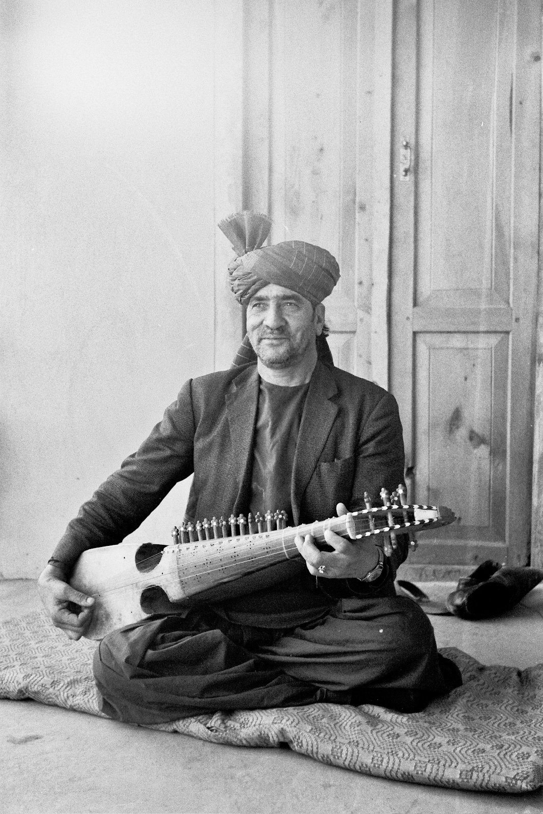 musician Ustad Amir Jan Khushnawaz playing the rubab