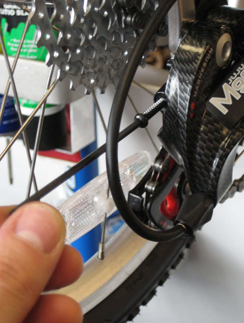By turning the B-screw in an anticlockwise direction and repositioning the derailleur, you can release some of the chain’s tension.