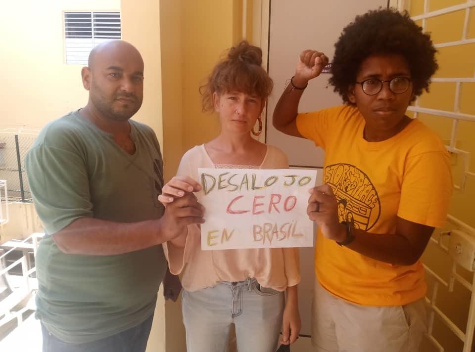 A group of people holding a sign

Description automatically generated