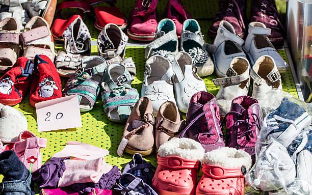 used girl baby and child shoes for charity or reusing display of used girl baby and child shoes for charity,donating,reusing or reselling for second life sold at garage sale at springtime second hand shoes stock pictures, royalty-free photos & images