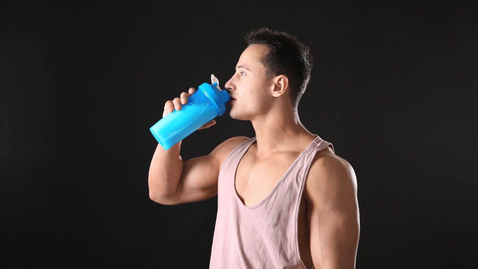 man drinking a pre-workout supplement