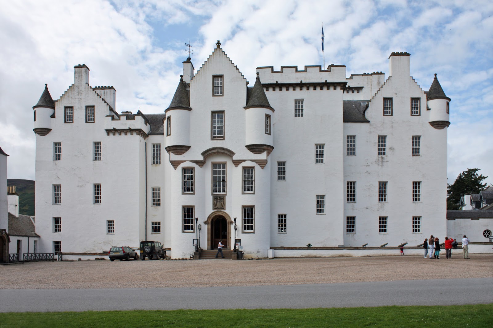 blair castle frontal view, symmetrical photo from across the castle shows its white walls, windows. cloudy day in great britain.