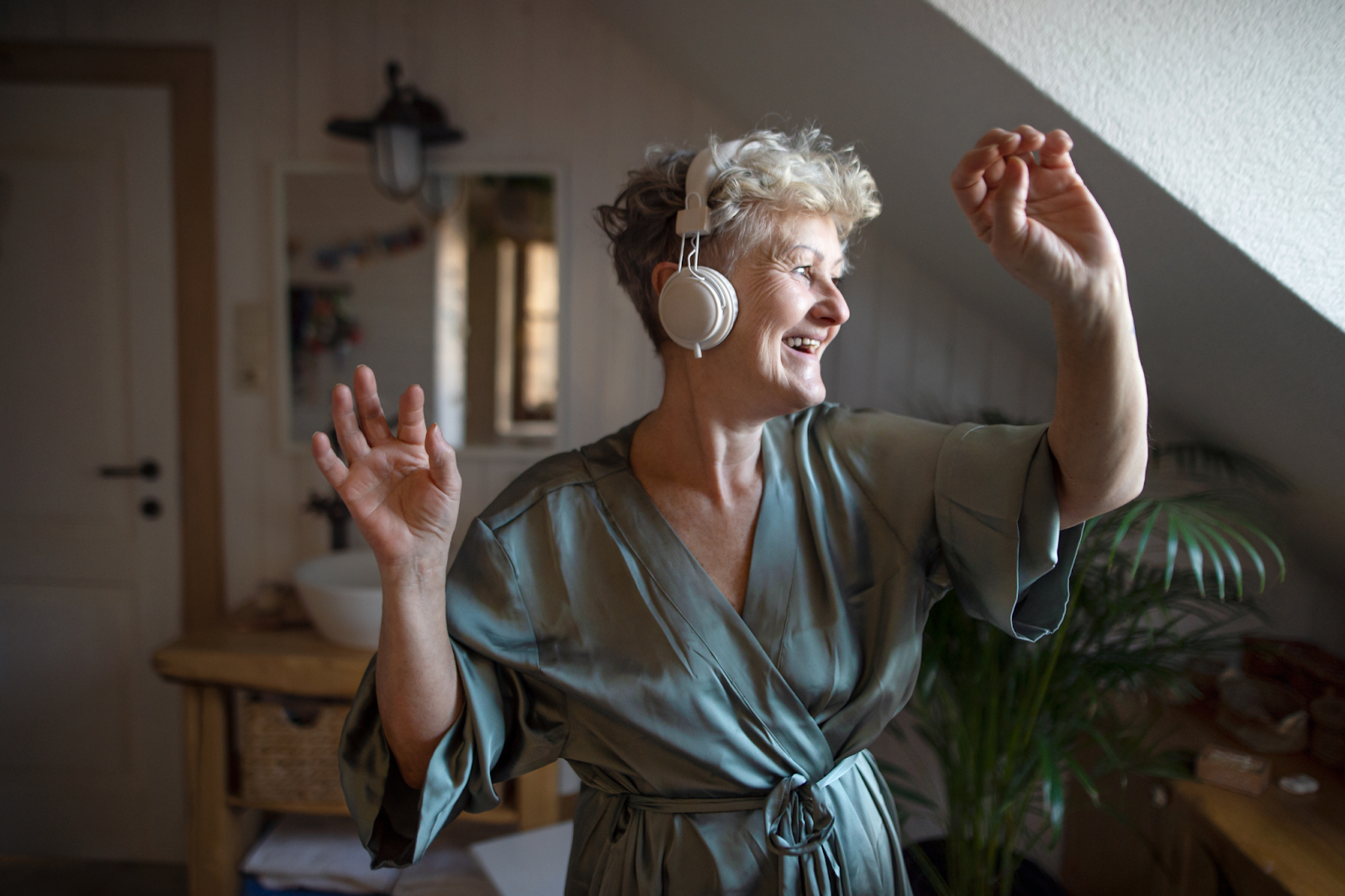 older woman enjoying herself with her headphones on 