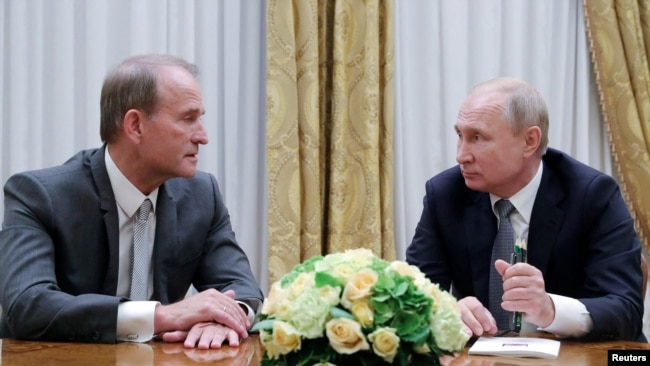 ФАЙЛ — Президент России Владимир Путин (справа) присутствует на встрече с лидером украинской оппозиционной платформы — партии «За жизнь» Виктором Медведчуком в Санкт-Петербурге, Россия, 18 июля 2019 года.