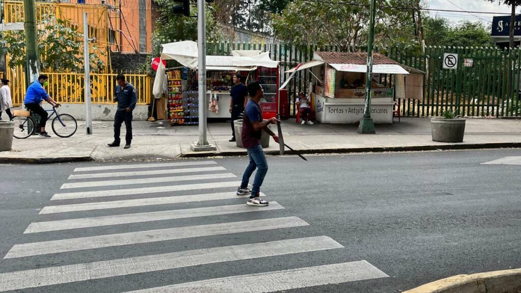 Machete juggler on a crosswalk.
