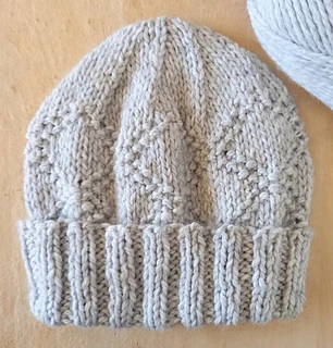 textured knitted hat for men on wooden surface