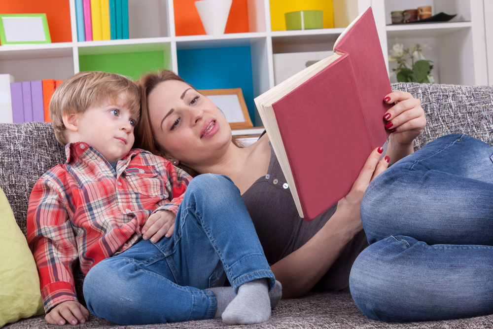 Mother and child reading a book to learn Adjectives For Kids