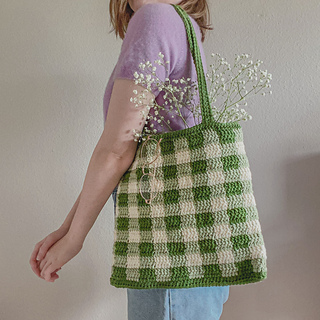 woman carrying a gingham tote bag