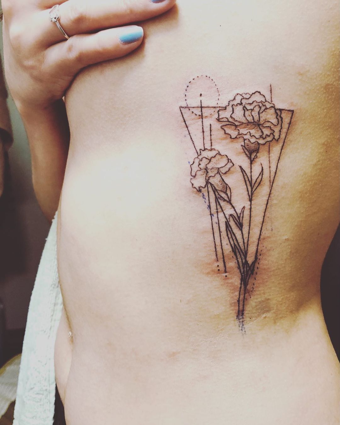 flowers in triangle tattoo