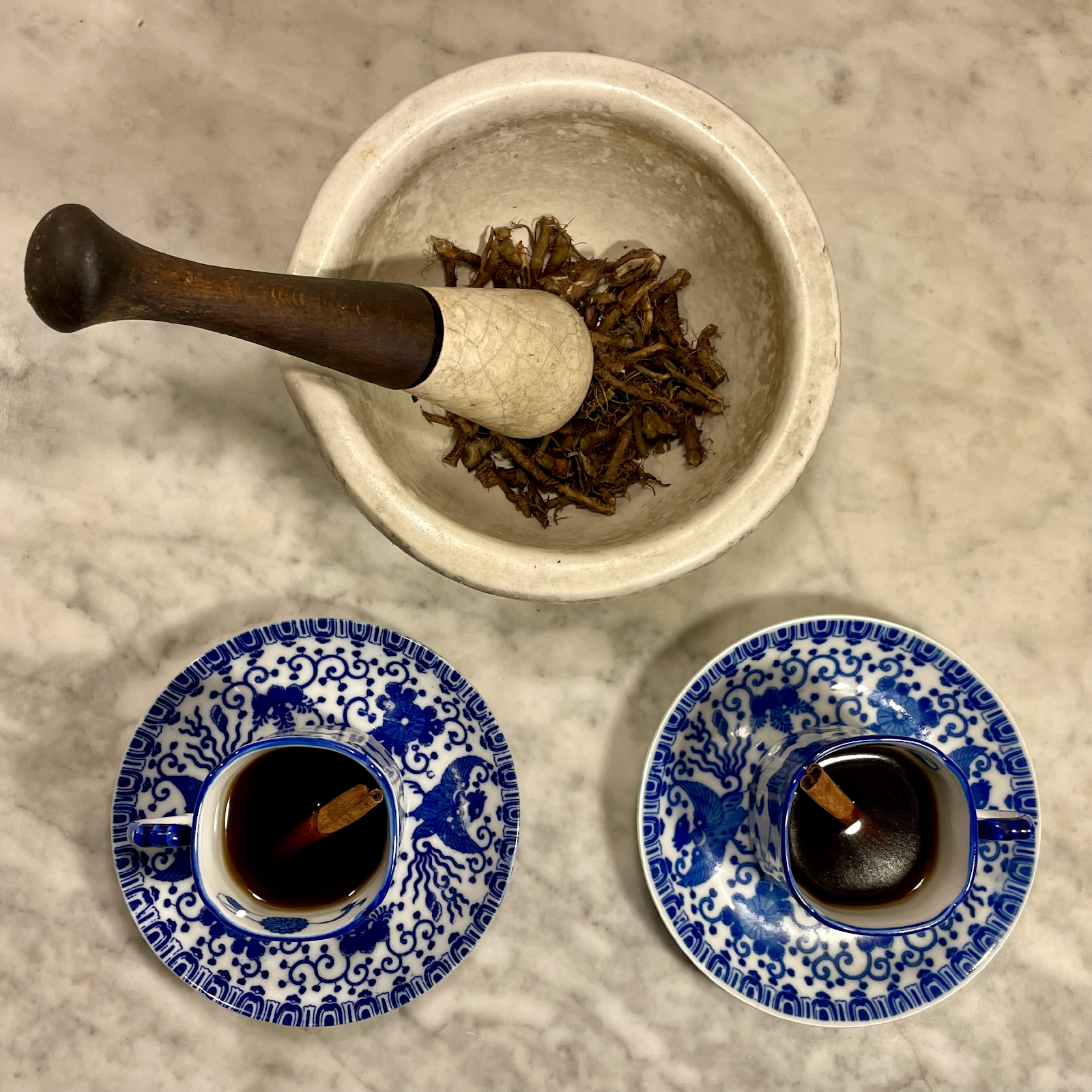  Roasted dandelion root coffee ground in mortar and pestle with cinnamon
 