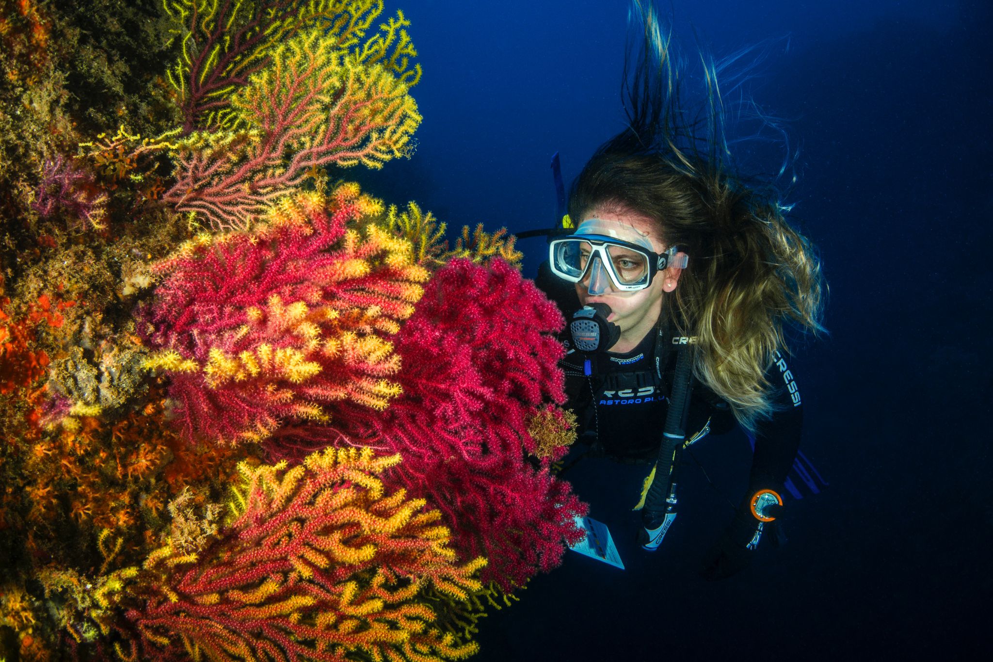 woman under water diving as one of the ways to explore while traveling
