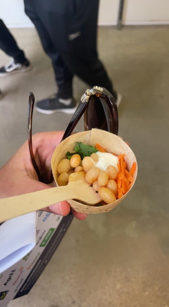 A hand holding a bowl of food

Description automatically generated with medium confidence