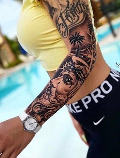 lady wearing a religious full sleeve tattoo on her arm