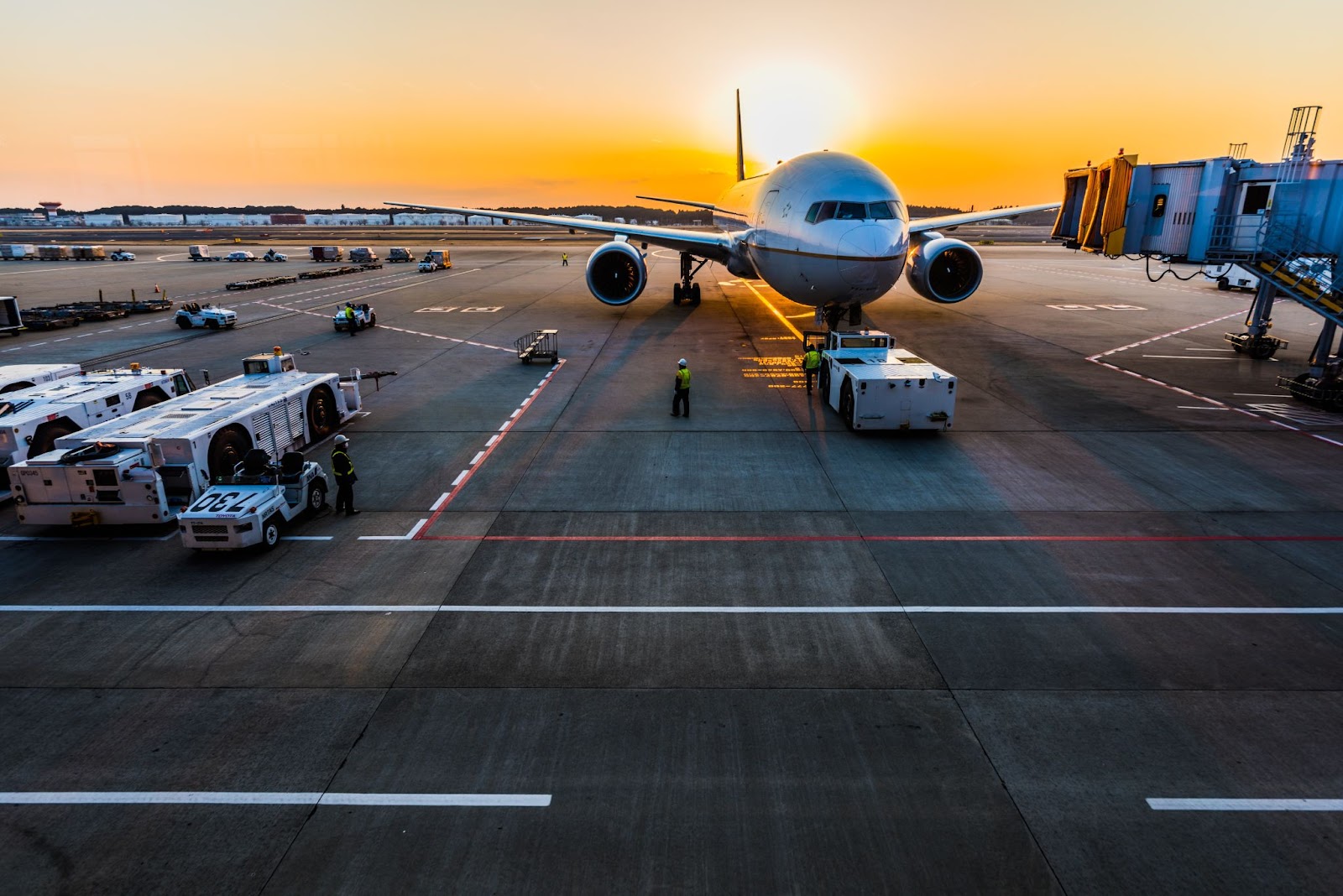 Airplane in terminal at sunset