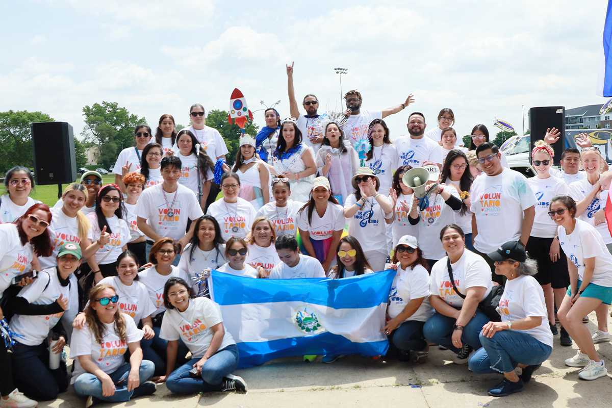 teachers holding the flag of el salvador during our 1K for kids celebration