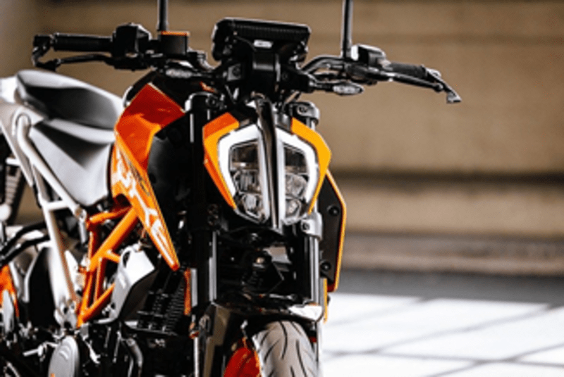 Front view of KTM 390 Duke motorcycle with fierce orange accents