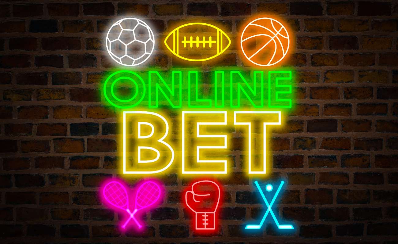 Online bet neon sign with different sports logos around it