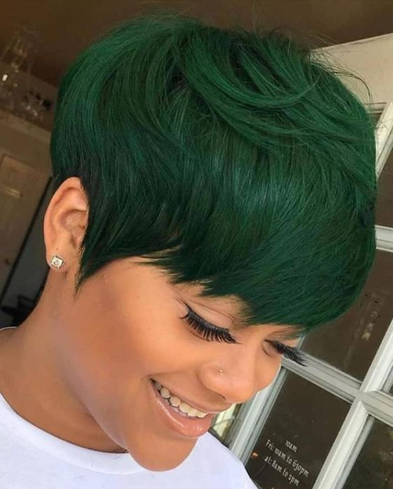 smiling lady wearing green pixie cut 