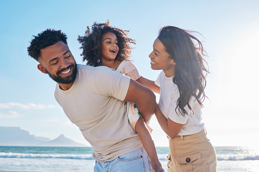 a black family at the beach looking happy. The father is carrying the daughter on his back as the mother has her hand on her daughter's back. Couples therapy and marriage counseling in Los Angeles, CA via online therapy in California with a marriage counselor can help.  91326
91303 | 91307 | 91377 | 91320