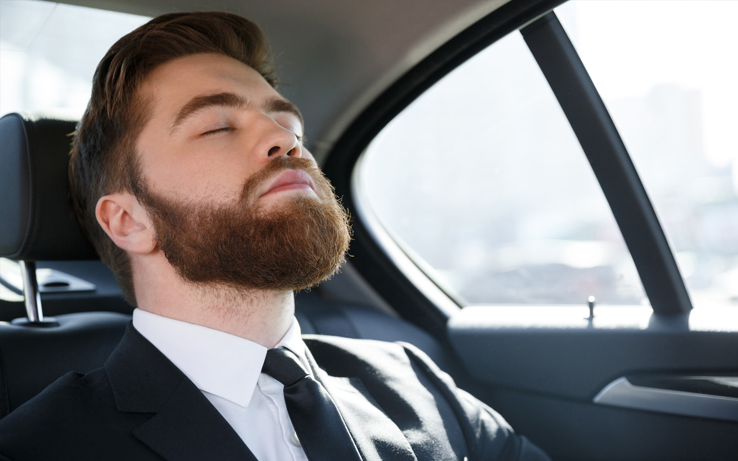man sleeping in car