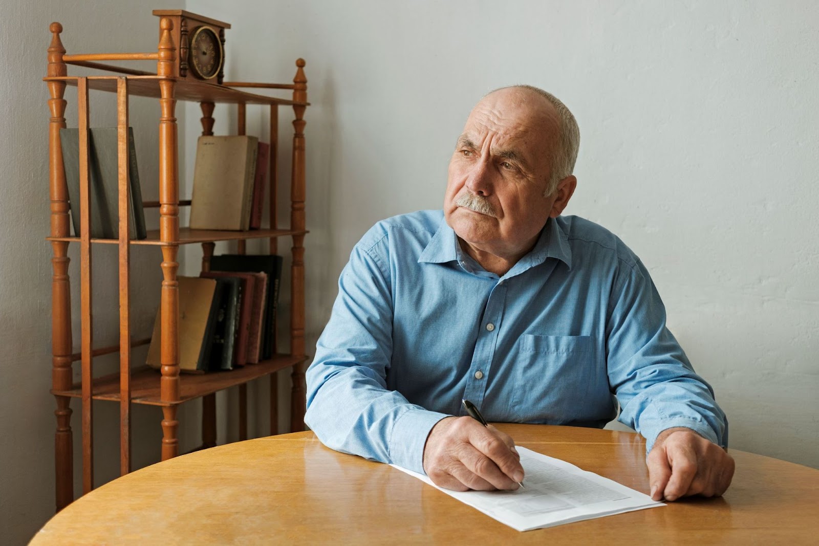 senior-man-looking-worried-and-writing