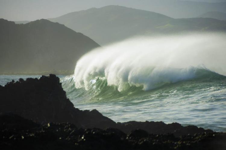 high waves breaking near rocks