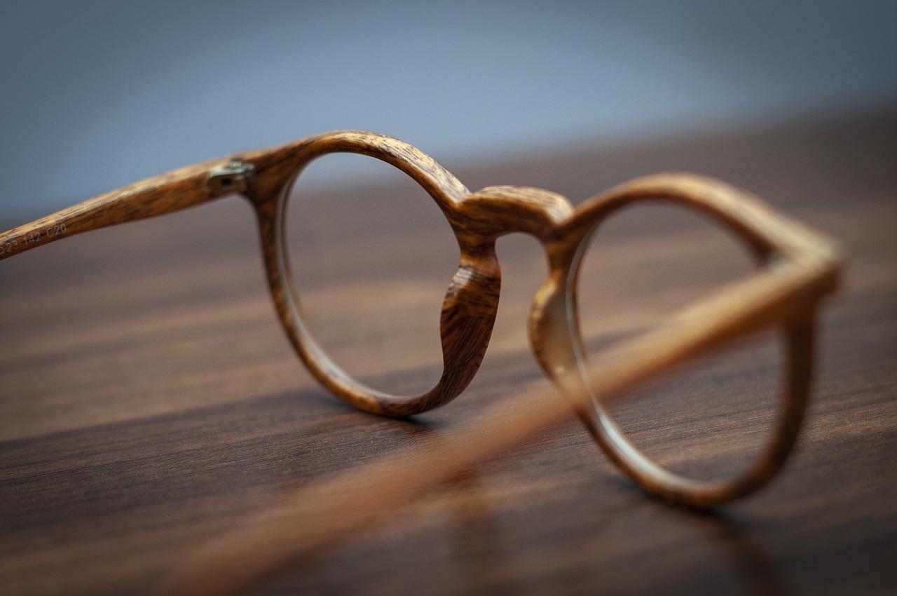 Close-up of a pair of glasses on a table Description automatically generated