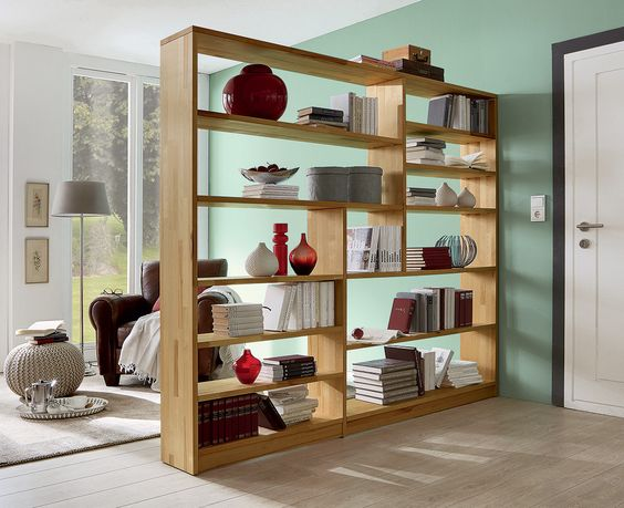 A bookcase divides the room to create two separate living spaces and provide additional storage. 