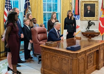 Justice Amy Coney Barrett (standing behind President Trump) was the last justice nominated by President Trump.