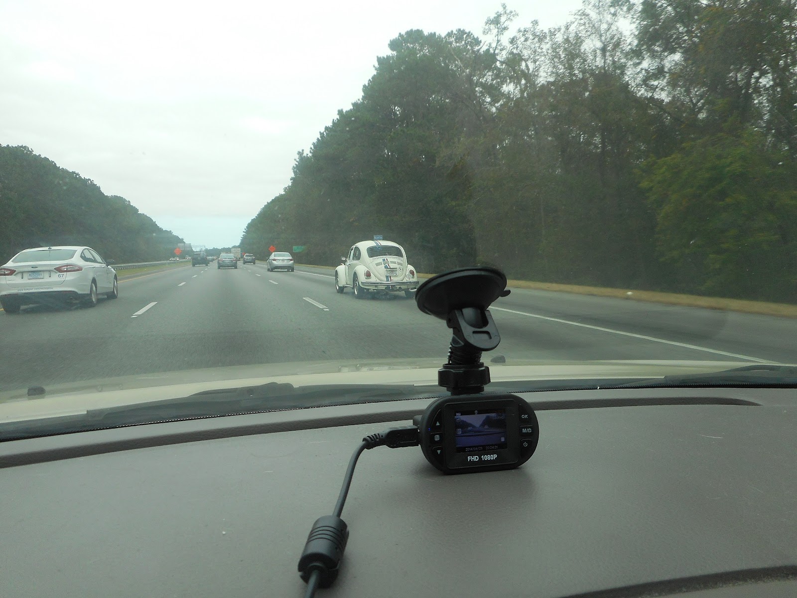 This image shows the Car Dashcam  near the car's front mirror.