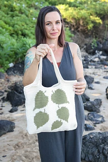 woman holding tote with colorwork leaves