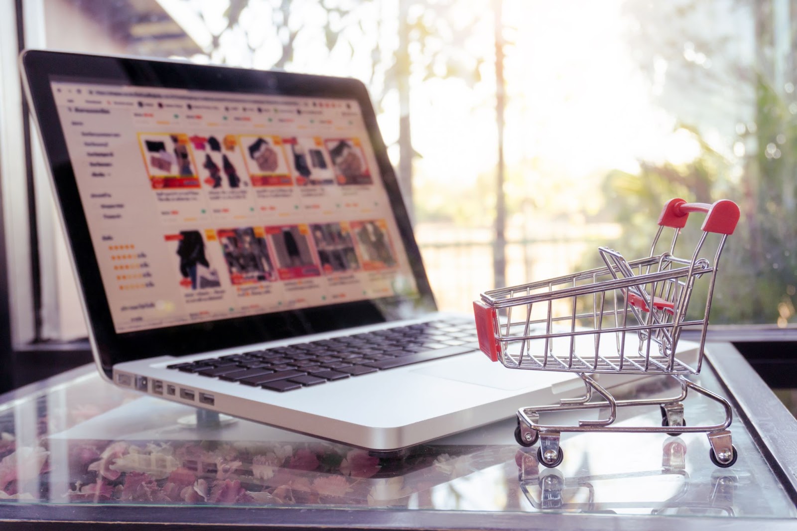 online-shopping-concept-shopping-cart-trolley-laptop-table