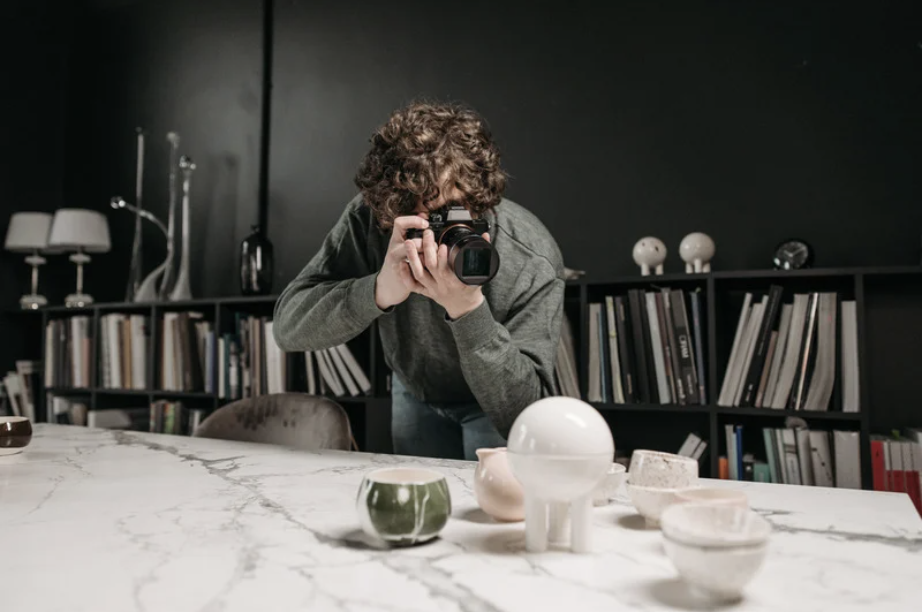 Photographer taking photos of ceramics for art portfolio
