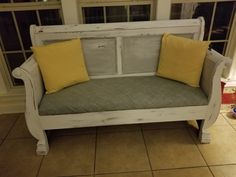 Saw the footboard in half and attach each half to the headboard to form the outline of the couch