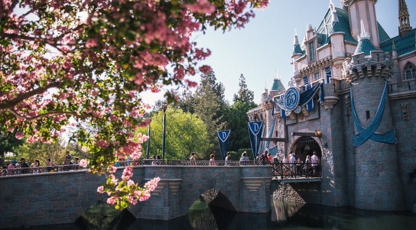 Visitors walk over the bridge into Sleeping Beauty’s castle, the focal point of Disneyland.