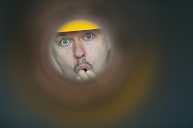Home Inspector Looking Through a Hole