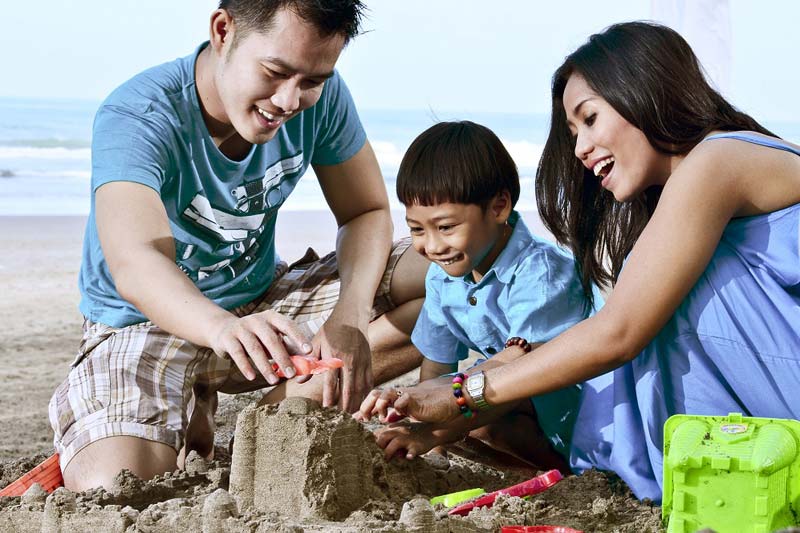 Parents with child at the beach.