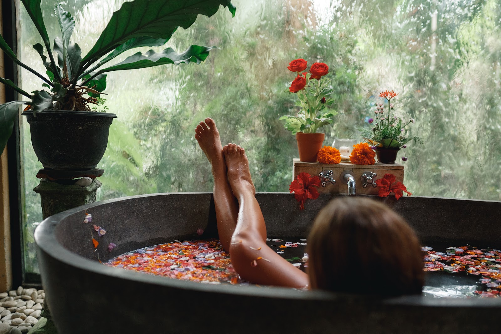 relaxing herbal spa with hot thermal bath surrounded by lush, greenery, silk towels and rosewater