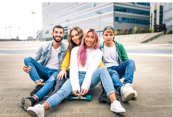 A group of people sitting on a sidewalk

Description automatically generated with low confidence