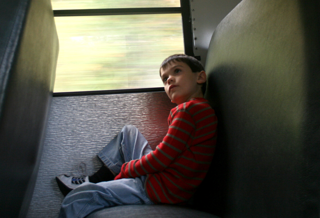 A child sitting on a train

Description automatically generated with medium confidence
