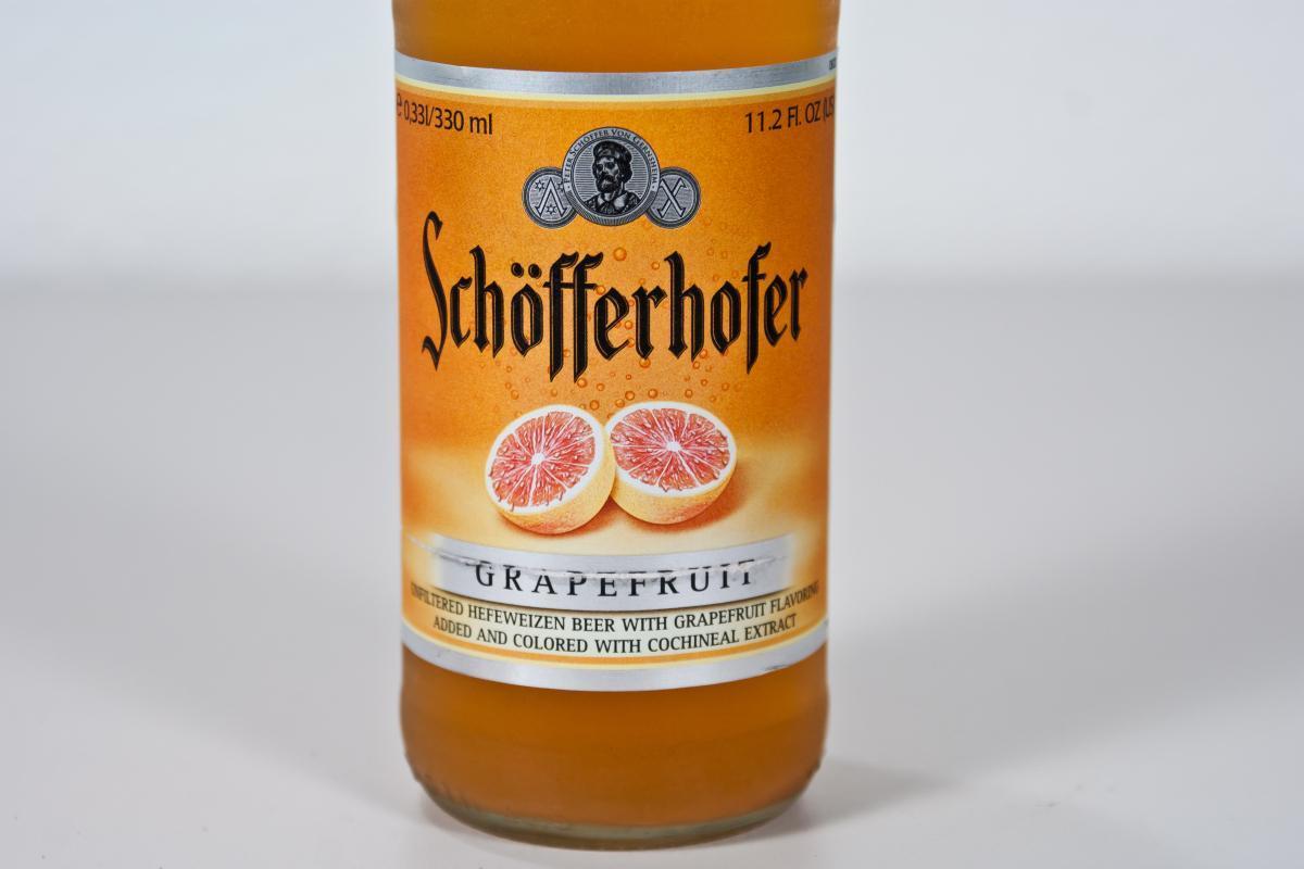 A bottle of low-alcohol Schöfferhofer grapefruit beer on a white table