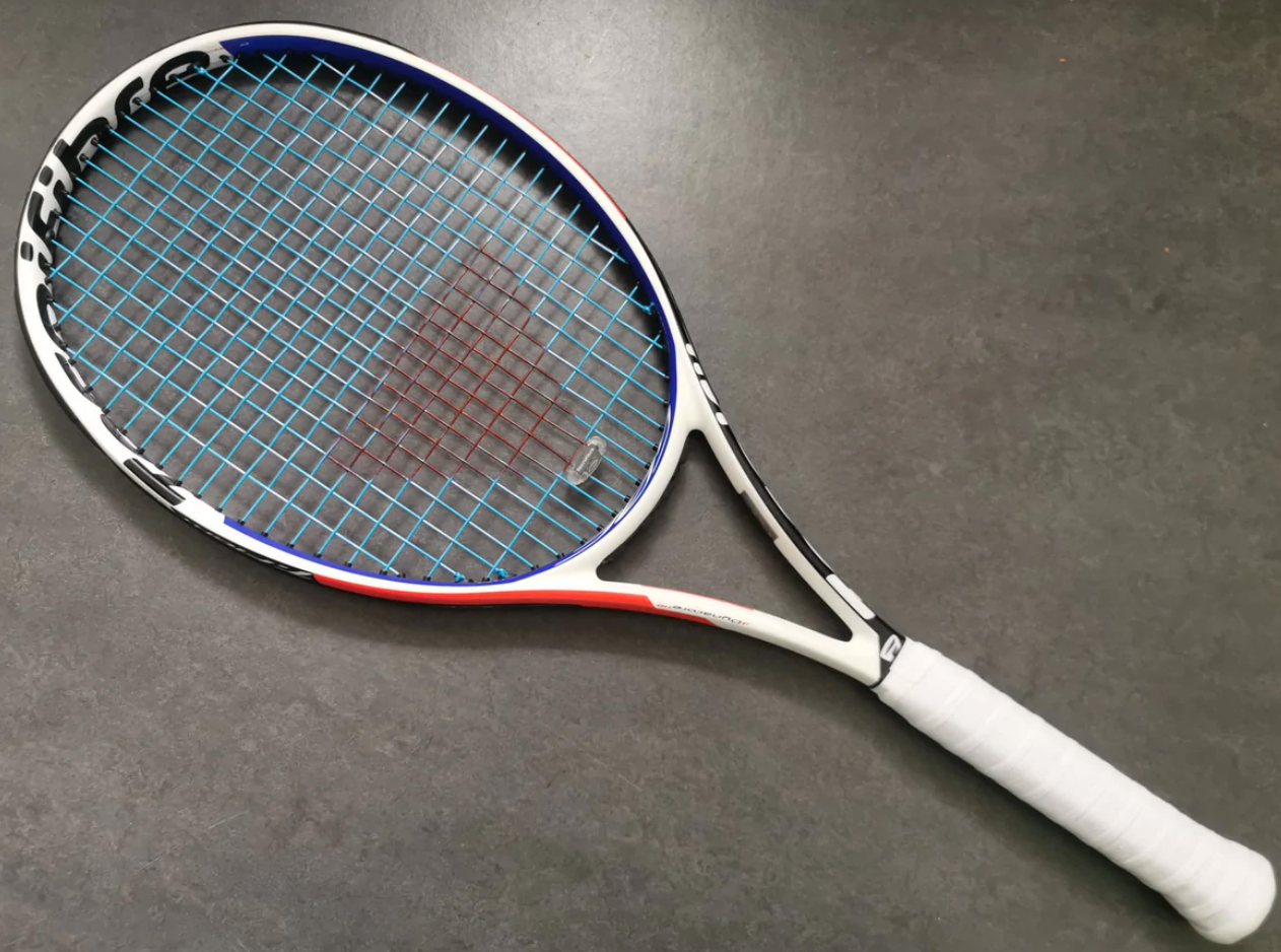 A tennis racket on the floor

Description automatically generated with medium confidence