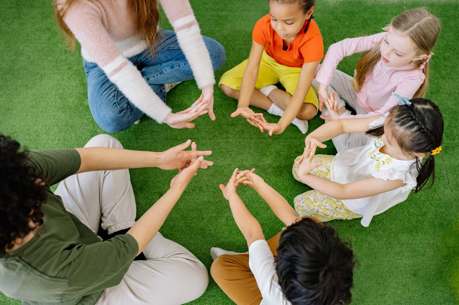 Children playing a finger game at circle time 