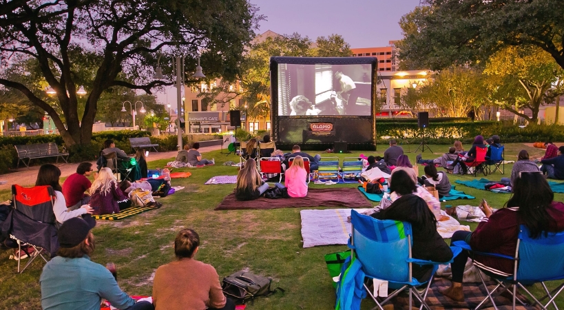 People watching a movie in a park in Downtown Houston